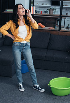 woman wearing orange jacket talking on a phone