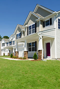 two story white house with green lawn